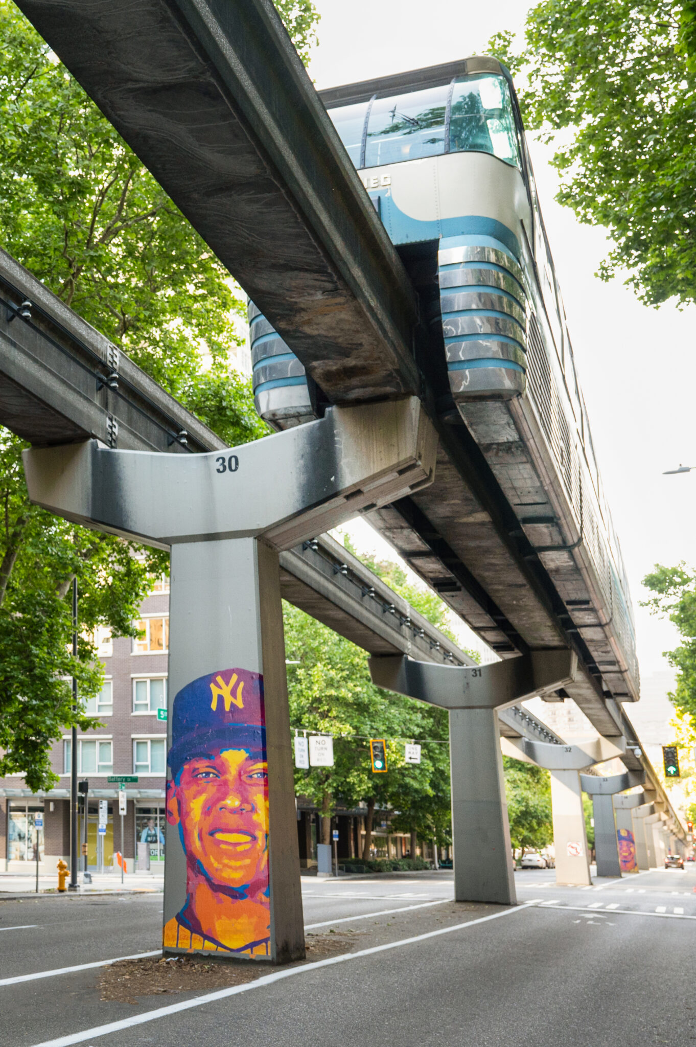 Yankees player mural with monorail running overhead